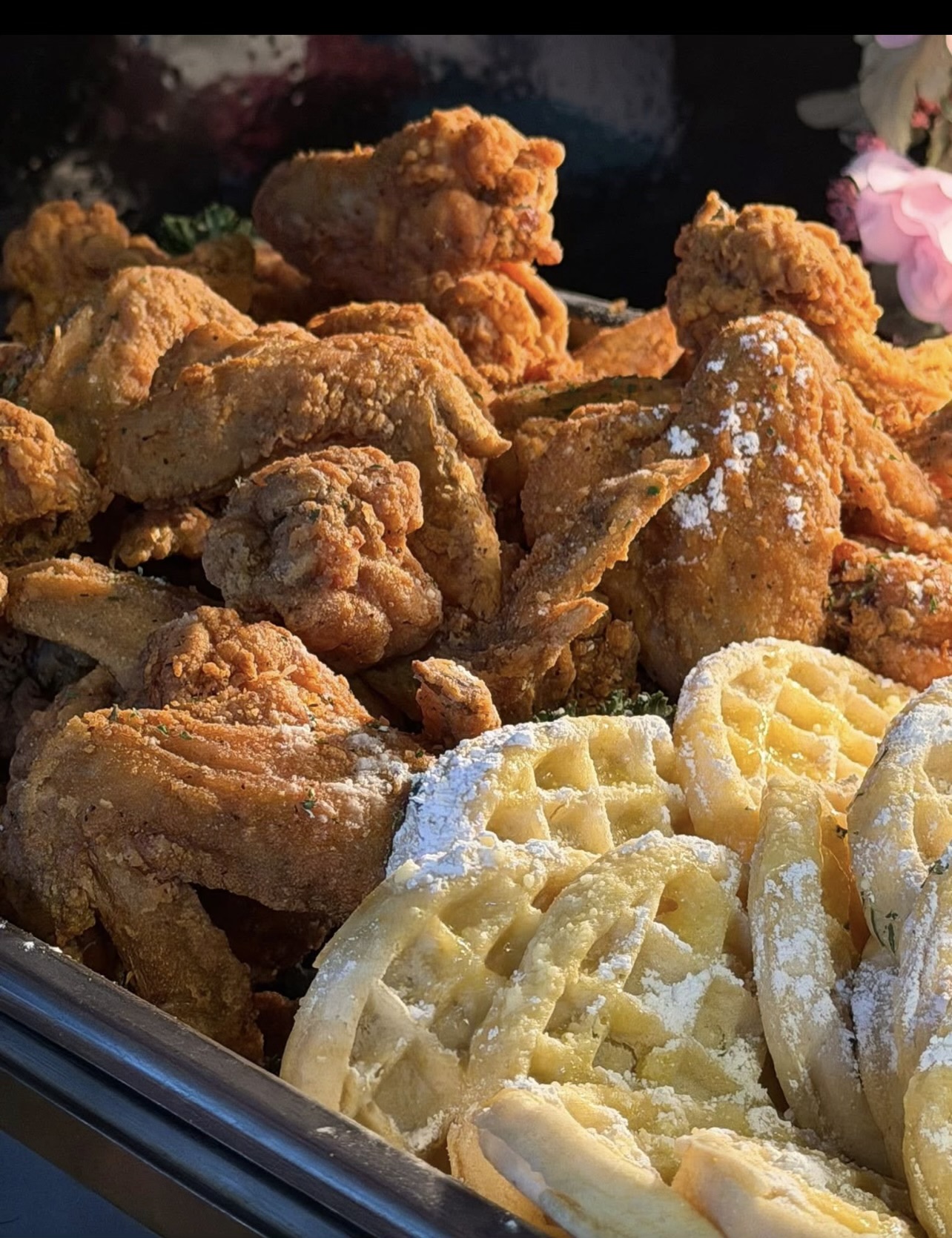 Golden fried chicken wings served with waffles
